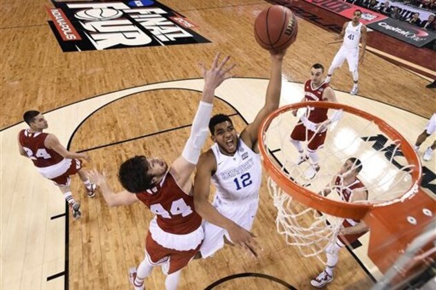 Kentucky's Karl-Anthony Towns (12) drives to the basket past Wisconsin's Frank Kaminsky (44) during the first half of the NCAA Final Four tournament college basketball semifinal game Saturday, April 4, 2015, in Indianapolis. (AP Photo/Chris Steppig, Pool)