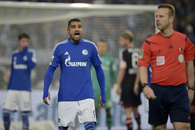 Schalke's Kevin-Prince Boateng, left, shouts to referee Peter Gagelmann during the German Bundesliga soccer match between FC Schalke 04 and Bayer Leverkusen in Gelsenkirchen,  Germany, Saturday, March 21, 2015. Schalke was defeated by Leverkusen with 0-1. (AP Photo/Martin Meissner)