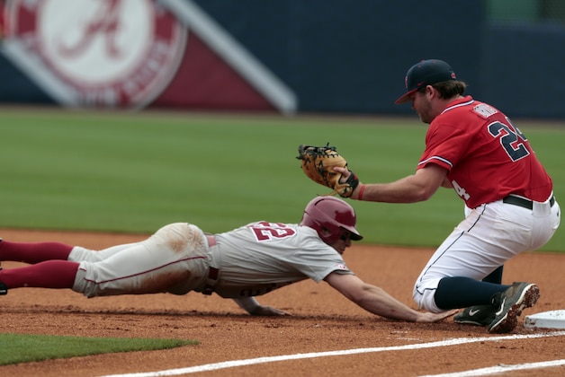 Alabama’s Georgie Salem beats the throw to Mississippi's Sikes Orvis as he dives safely back to first during the first inning of the Southeastern Conference college baseball tournament at the Hoover Met, Tuesday, May 19, 2015, in Hoover, Ala. (AP Photo/Butch Dill)