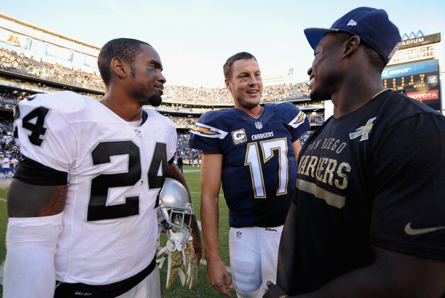 SAN DIEGO, CA - NOVEMBER 16:  Charles Woodson #24 (L) of the Oakland Raiders and quarterback Philip Rivers #17 of the San Diego Chargers smile after the Chargers defeated the Oakland Raiders 13-6 in the game at Qualcomm Stadium on November 16, 2014 in San Diego, California.  (Photo by Donald Miralle/Getty Images)