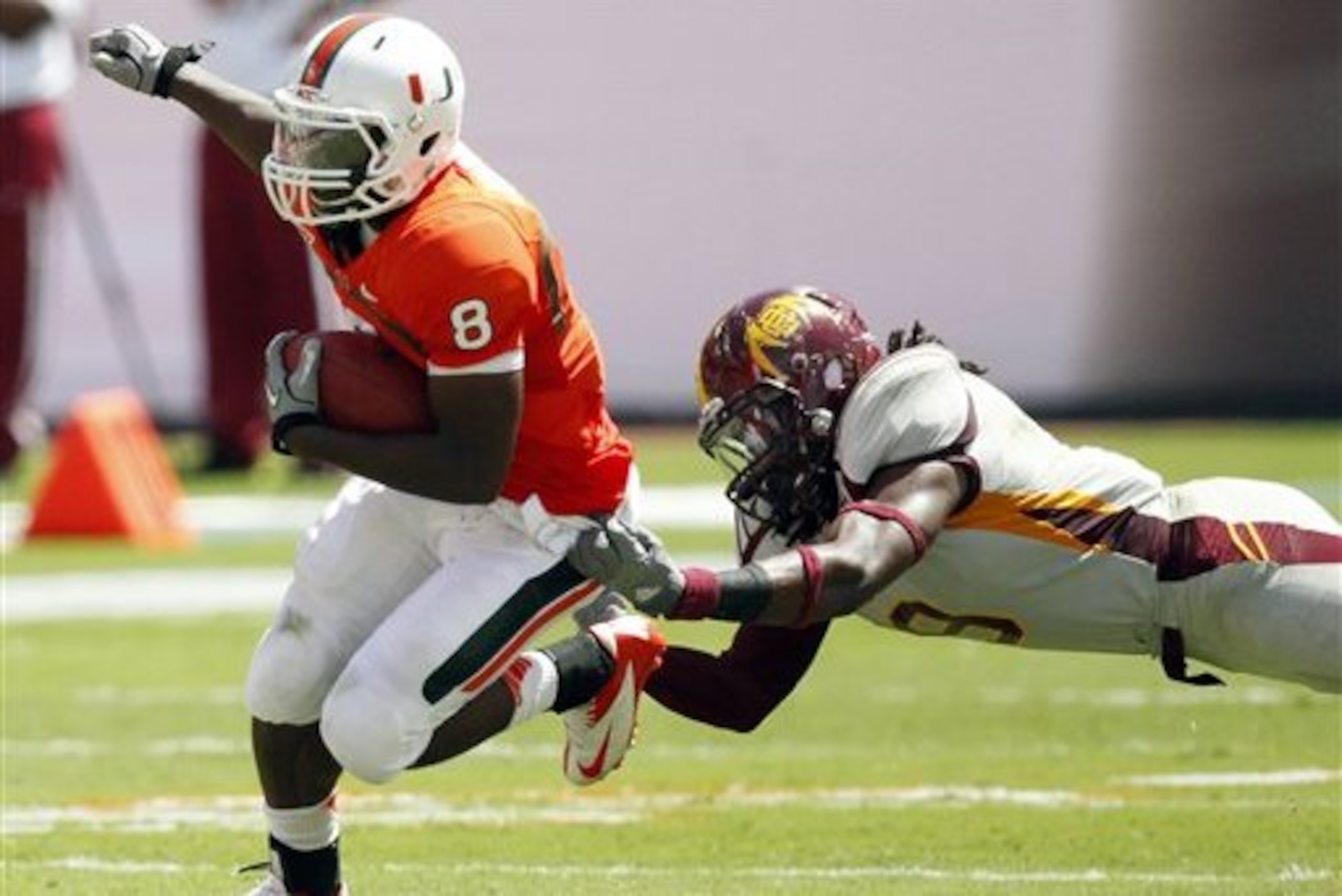 Bethune-Cookman linebacker Tavarus Dantzler, right, attempts to tackle Miami running back Duke Johnson (8) in the first half of an NCAA college football game, Saturday, Sept. 15, 2012, in Miami. Miami won 38-10. (AP Photo/Wilfredo Lee)