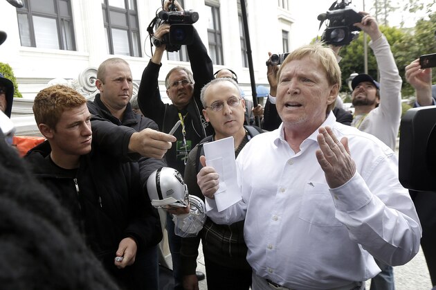 Oakland Raiders owner Mark Davis, right, speaks to fans outside of the NFL's spring meetings in San Francisco, Tuesday, May 19, 2015. (AP Photo/Jeff Chiu)