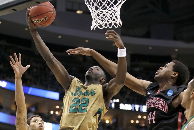 Notre Dame's Jerian Grant (22) shoots around Northeastern's Reggie Spencer, right, during the first half of a second round game in the NCAA college basketball tournament, Thursday, March 19, 2015, in Pittsburgh. (AP Photo/Gene J. Puskar)