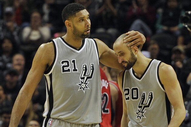 San Antonio Spurs forward Tim Duncan, left, congratulates Spurs guard Manu Ginobili, of Argentina, on a basket in the second half of an NBA basketball game, Friday, Dec. 19, 2014, in San Antonio. (AP Photo/Darren Abate)