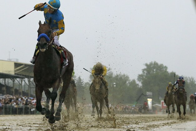 Jockey Victor Espinoza, left, celebrates aboard American Pharoah after winning the 140th Preakness Stakes horse race at Pimlico Race Course, Saturday, May 16, 2015, in Baltimore.  (AP Photo/Matt Slocum)