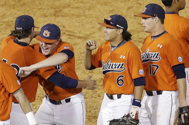 Auburn pitcher Trey Wingenter, center left, hugs pitcher Cole Lipscomb after Auburn defeated Kentucky in a Southeastern Conference college baseball tournament game Tuesday, May 19, 2015, in Hoover, Ala. Auburn won 6-3. (AP Photo/Brynn Anderson)