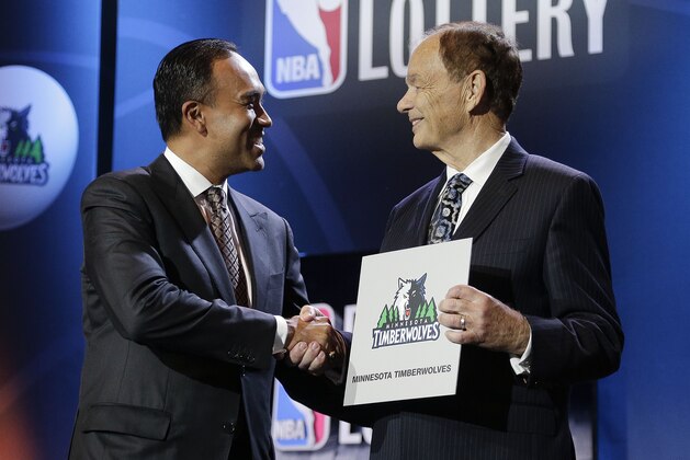 NBA Deputy Commissioner Mark Tatum, left, congratulates Minnesota Timberwolves owner Glen Taylor after the Timberwolves won the first pick in the draft, during the NBA basekball draft lottery, Tuesday, May 19, 2015, in New York. (AP Photo/Julie Jacobson)