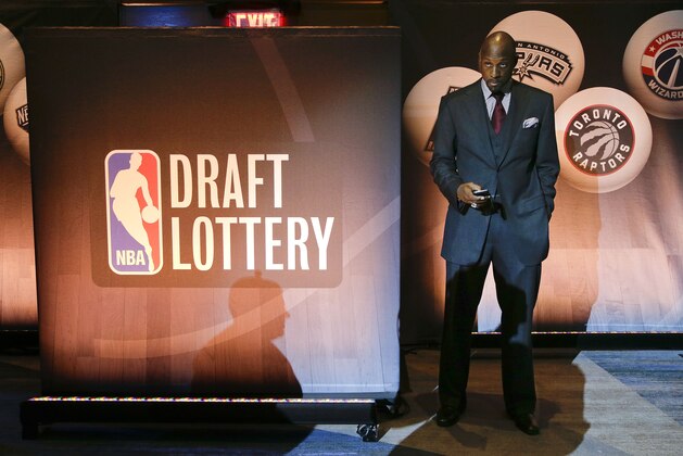 Miami Heat vice president Alonzo Mourning checks his cell phone before NBA basketball draft lottery, Tuesday, May 19, 2015, in New York. (AP Photo/Julie Jacobson)