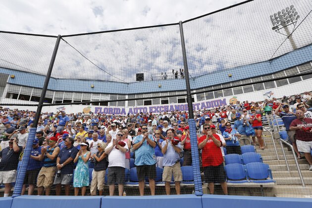 Baseball fans applaud after the Canadian and the American National Anthems were sung before the start of an exhibition baseball game between the Toronto Blue Jays and the Philadelphia Phillies in Dunedin, Fla., Thursday, March 26, 2015. (AP Photo/Kathy Willens)