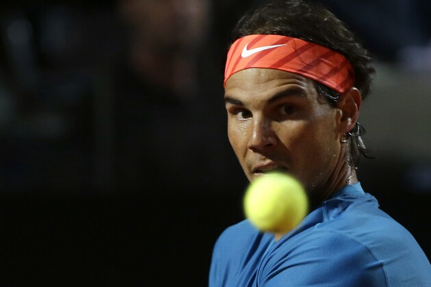 Spain's Rafael Nadal  returns the ball to Switzerland's Stan Wawrinka during a quarter final match at the Italian Open tennis tournament, in Rome, Friday, May 15, 2015. (AP Photo/Alessandra Tarantino)