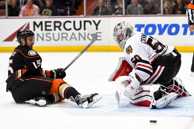 Chicago Blackhawks goalie Corey Crawford, right, blocks a shot by Anaheim Ducks center Ryan Getzlaf during overtime in Game 2 of the Western Conference final during the NHL hockey Stanley Cup playoffs in Anaheim, Calif., on Tuesday, May 19, 2015. (AP Photo/Mark J. Terrill)