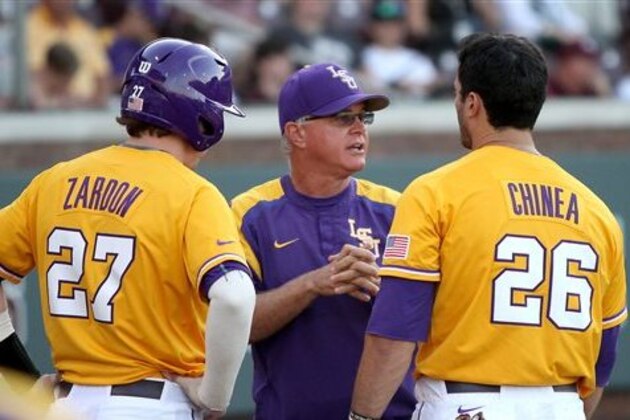 LSU head coach Paul Mainieri, center, discusses the game with Danny Zardon (27) and Chris Chinea (26) during the 11th inning of an NCAA college baseball game against Mississippi State in Starkville, Miss., Saturday, May 2, 2015. (AP Photo/Jim Lytle)