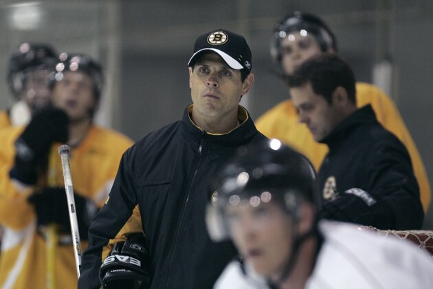 Boston Bruins director of player development Don Sweeney, center, watches play during a hockey team development camp in Wilmington, Mass. Monday, July 9, 2007.(AP Photo/Charles Krupa)