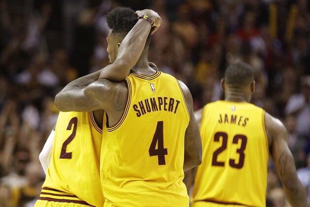 Cleveland Cavaliers guard Iman Shumpert (4) hugs Cleveland Cavaliers guard Kyrie Irving (2) late in the second half against the Chicago Bulls during Game 5 in a second-round NBA basketball playoff series Tuesday, May 12, 2015, in Cleveland. The Cavaliers won 106-101. (AP Photo/Tony Dejak)