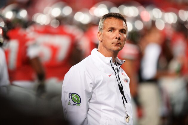 COLUMBUS, OH - SEPTEMBER 28:  Head Coach Urban Meyer of the Ohio State Buckeyes watches his team warm up before a game against the Wisconsin Badgers at Ohio Stadium on September 28, 2013 in Columbus, Ohio.  (Photo by Jamie Sabau/Getty Images)