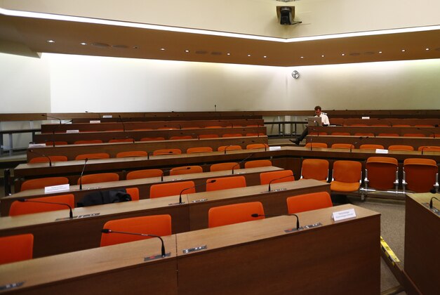 People wait for the start of the trial against Beate Zschaepe alleged member of the neo-Nazi group National Socialist Underground, NSU, in a court room in Munich, Germany,  Monday, May 11, 2015. Zschaepe, is accused by prosecutor of complicity in the murder of eight Turks, a Greek and a policewoman between 2000 and 2007. Zschaepe is also accused of involvement in at least two bombings and 15 bank robberies carried out by her accomplices Uwe Mundlos and Uwe Boenhardt, who died in an apparent suicide in November 2011. (AP Photo/Matthias Schrader)