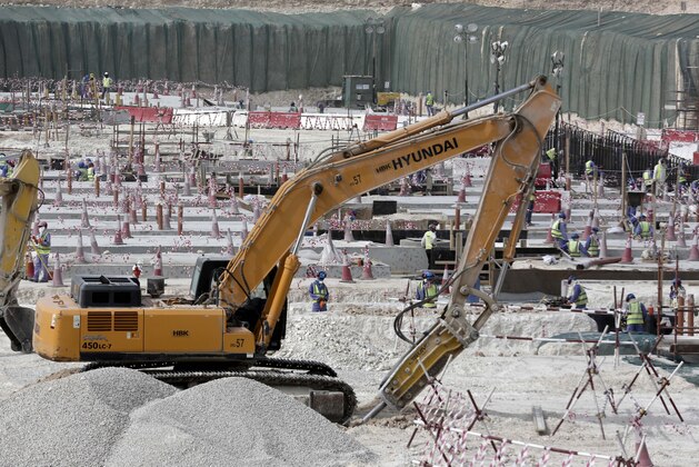 In this photo taken during a government organized media tour, workers use heavy machinery at the Al-Wakra Stadium being built for the 2022 World Cup, in Doha, Qatar, Monday, May 4, 2015. Qatar’s inability to ensure decent housing for its bulging migrant labor population was “a mistake” the government is working to fix as it prepares to host the 2022 World Cup, the country’s top labor official said Monday, vowing his country would improve conditions for its vast foreign labor force. (AP Photo/Maya Alleruzzo)