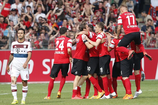 Freiburg's players celebrate after winning the German first division Bundesliga soccer match between SC Freiburg and Bayern Munich in Freiburg, Germany, Saturday, May 16, 2015. (AP Photo/Michael Probst)