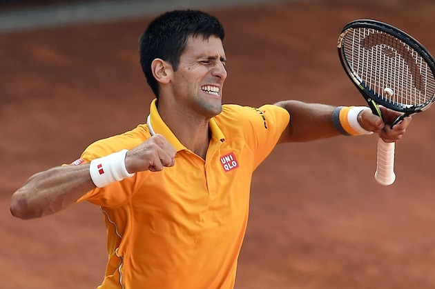 Serbia's Novak Djokovic celebrates after defeating Switzerland's Roger Federer in their men's final match at the Italian Open tennis tournament, in Rome, Sunday, May 17, 2015. Djokovic won 6-4 6-3. (Claudio Onorati/ANSA via AP) ITALY OUT