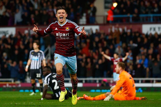 LONDON, ENGLAND - NOVEMBER 29:  Aaron Cresswell of West Ham celebrates scoring opening goal past Robert Elliot of Newcastle United during the Barclays Premier League match between West Ham United and Newcastle United at Boleyn Ground on November 29, 2014 in London, England.  (Photo by Julian Finney/Getty Images)