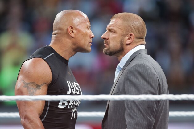 IMAGE DISTRIBUTED FOR WWE - Dwayne the Rock Johnson stares off against WWE superstar Triple H at WrestleMania 31 on Sunday, March 29, 2015 in Santa Clara, CA. WrestleMania broke the Levi’s Stadium attendance record at 76,976 fans from all 50 states and 40 countries. (Don Feria/AP Images for WWE)