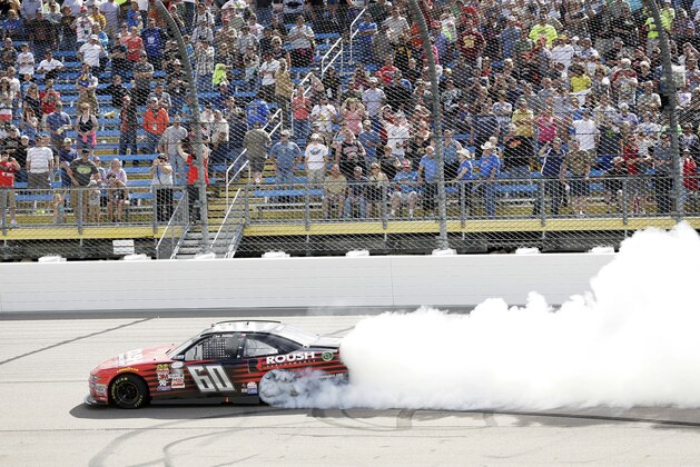 Chris Buescher does a burnout after winning the NASCAR Xfinity Series auto race, Sunday, May 17, 2015, at Iowa Speedway in Newton, Iowa. (AP Photo/Charlie Neibergall)