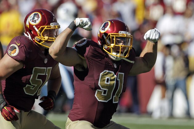 ADVANCE FOR WEEKEND EDITIONS, DEC. 13-14 - FILE -  In this Oct. 19, 2014, file photo, Washington Redskins linebackers Ryan Kerrigan (91) and Will Compton (51) celebrate Kerrigan's sack during the second half of an NFL football game against the Tennessee Titans in Landover, Md. For those who believe the guys who throw the football decide all NFL games, keep an eye on the guys who try to get those passers on the ground. (AP Photo/Mark E. Tenally, File)