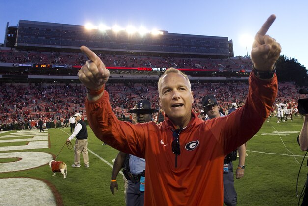 FILE - In this Oct. 4, 2014, file photo, Georgia head coach Mark Richt gestures towards the band after defeating Vanderbilt  44-17 in an NCAA college football game in Athens, Ga. Georgia football coach Richt has received a two-year contract extension that ties him to the Bulldogs through 2019 and increases his salary to $4 million a year. The school's executive committee approved the new contract Wednesday, Jan. 21, 2015, boosting Richt from $3.2 million a year. (AP Photo/John Bazemore, File)
