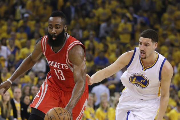 Houston Rockets' James Harden, left, drives the ball past Golden State Warriors' Klay Thompson (11) during the first quarter of Game 1 of the NBA basketball Western Conference finals Tuesday, May 19, 2015, in Oakland, Calif. (AP Photo/Ben Margot)