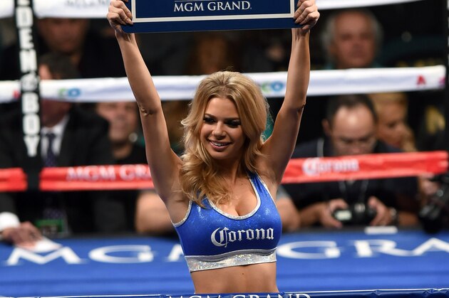 LAS VEGAS, NV - DECEMBER 13:  A ring card girl signals the start of round three of the super featherweight bout between Abner Mares and Jose Ramirez at the MGM Grand Garden Arena on December 13, 2014 in Las Vegas, Nevada. Mares won by TKO when the fight was stopped after the fifth round.  (Photo by Ethan Miller/Getty Images)