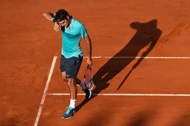 ROME, ITALY - MAY 17:  Roger Federer of Switzerland finds the going tough during his straight sets loss to Novak Djokovic of Serbia in the Men's Singles Final on Day Eight of The Internazionali BNL d'Italia 2015 at the Foro Italico on May 17, 2015 in Rome, Italy.  (Photo by Mike Hewitt/Getty Images)