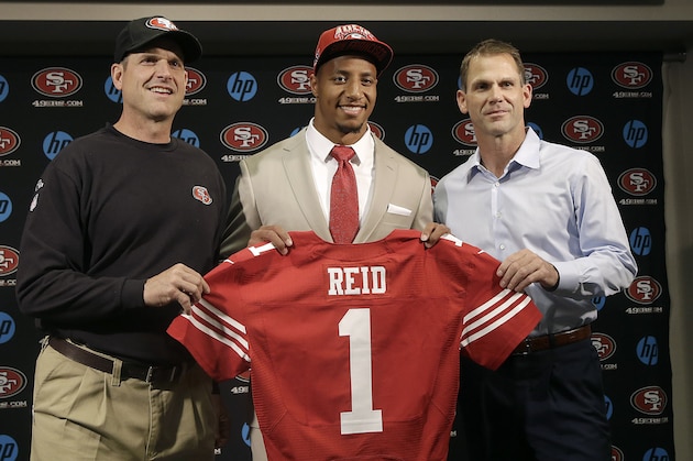 Safety Eric Reid, the first-round draft pick of the San Francisco 49ers, center, holds up a jersey with head coach Jim Harbaugh, left, and general manager Trent Baalke during a news conference at the team's training facility in Santa Clara, Calif., Friday, April 26, 2013. (AP Photo/Jeff Chiu)
