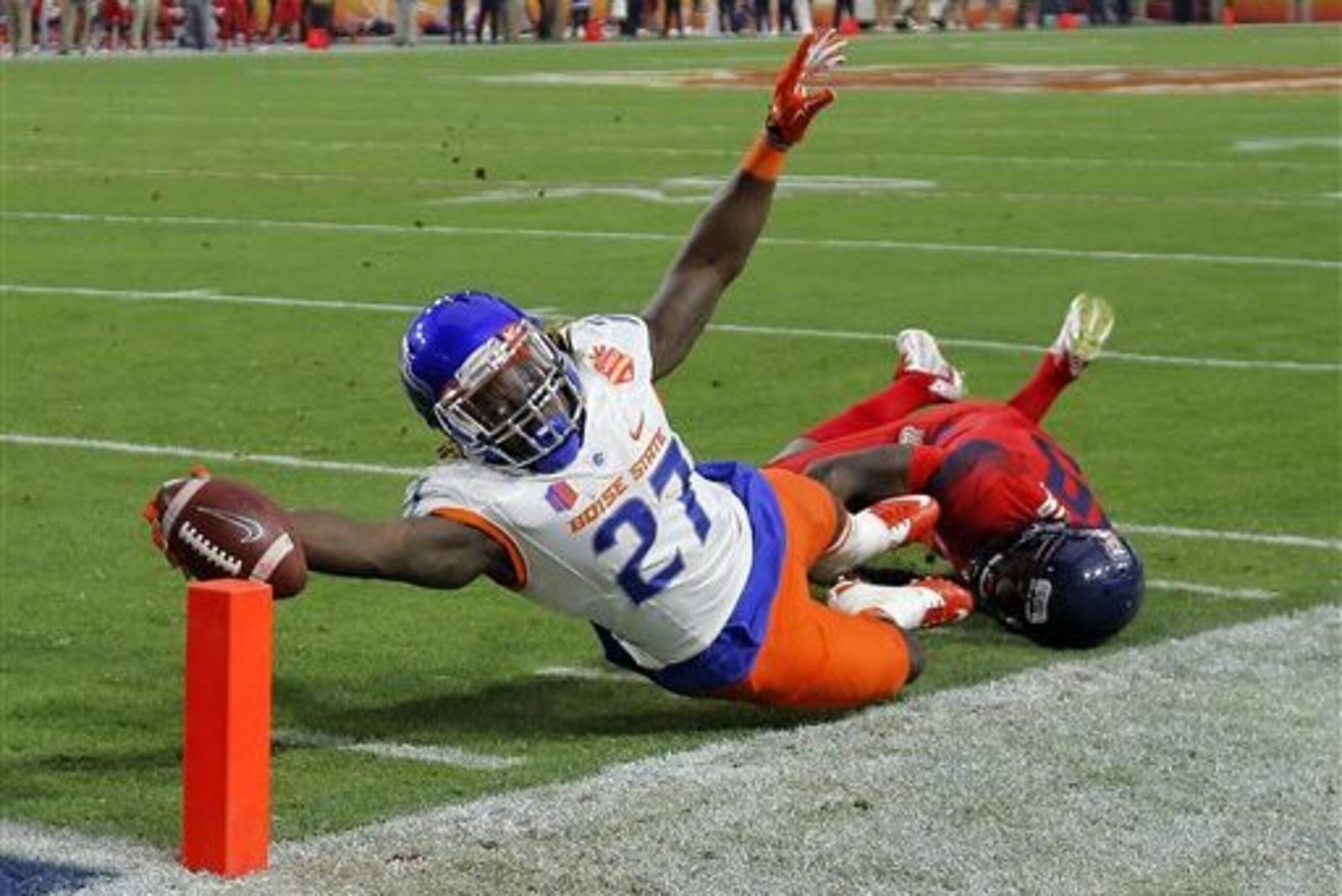 Boise State running back Jay Ajayi dives for the touchdown as Arizona cornerback Jarvis McCall Jr. defends during the first half of the Fiesta Bowl NCAA college football game, Wednesday, Dec. 31, 2014, in Glendale, Ariz. (AP Photo/Rick Scuteri)