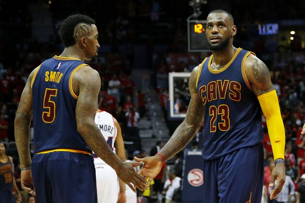 ATLANTA, GA - MAY 20:  LeBron James #23 and J.R. Smith #5 of the Cleveland Cavaliers react after Iman Shumpert #4 drew a foul in the second half against the Atlanta Hawks during Game One of the Eastern Conference Finals of the 2015 NBA Playoffs at Philips Arena on May 20, 2015 in Atlanta, Georgia. NOTE TO USER: User expressly acknowledges and agrees that, by downloading and or using this Photograph, user is consenting to the terms and conditions of the Getty Images License Agreement.  (Photo by Kevin C. Cox/Getty Images)