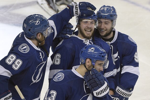 Tampa Bay Lightning right wing Nikita Kucherov (86), of Russia, celebrates with teammates, including defenseman Nikita Nesterov (89), of Russia, and center Tyler Johnson (9) after scoring the game-winning goal against the New York Rangers during the overtime period of Game 3 of the Eastern Conference finals during an NHL hockey Stanley Cup playoffs Wednesday, May 20, 2015, in Tampa, Fla. (AP Photo/Phelan M. Ebenhack)