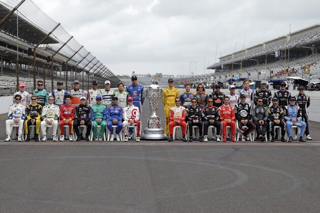 The starting line up for the Indianapolis 500 pose on the start/finish line before the start of practice for the Indianapolis 500 auto race at Indianapolis Motor Speedway in Indianapolis, Monday, May 18, 2015.  (AP Photo/Darron Cummings)