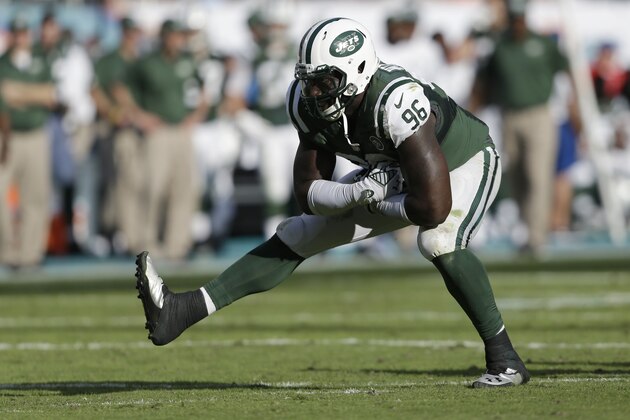 New York Jets defensive end Muhammad Wilkerson (96) celebrates after sacking Miami Dolphins quarterback Ryan Tannehill during the second half of an NFL football game, Sunday, Dec. 28, 2014, in Miami Gardens, Fla. (AP Photo/Wilfredo Lee)