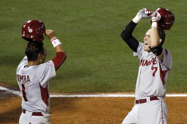 Arkansas’s Bobby Wernes (7) celebrates with Rick Nomura (1) after he hit a two run homer to go ahead of Florida and hold on to win 7-6 during the ninth inning of a game at the Southeastern Conference college baseball tournament at the Hoover Met, Thursday, May 21, 2015, in Hoover, Ala. (AP Photo/Butch Dill)