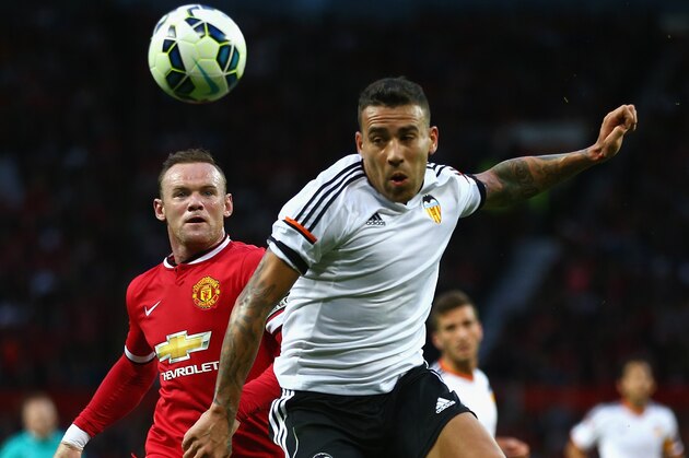 MANCHESTER, ENGLAND - AUGUST 12: Wayne Rooney of Manchester United in action with  Nicolas Otamendi of Valencia during the Pre Season Friendly match between Manchester United and Valencia at Old Trafford on August 12, 2014 in Manchester, England.  (Photo by Clive Brunskill/Getty Images)