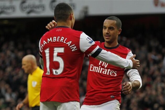 Arsenal's Theo Walcott, right, celebrates his goal against Tottenham Hotspur with teammate Alex Oxlade-Chamberlain during their English Premier League soccer match at Emirates stadium, London, Saturday, Nov. 17, 2012. (AP Photo/Sang Tan)
