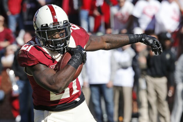 Oklahoma running back Keith Ford (21) carries during an NCAA college football game between Baylor and Oklahoma in Norman, Okla., Saturday, Nov. 8, 2014. Baylor won 48-14. (AP Photo/Sue Ogrocki)