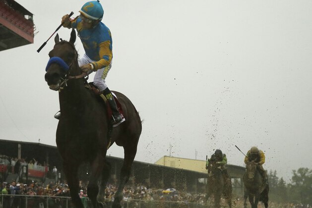 American Pharoah, ridden by Victor Espinoza  wins the 140th Preakness Stakes horse race at Pimlico Race Course, Saturday, May 16, 2015, in Baltimore. (AP Photo/Matt Slocum)