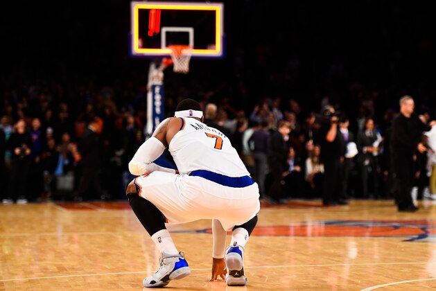 NEW YORK, NY - NOVEMBER 14: Carmelo Anthony #7 of the New York Knicks kneels down after losing to the Utah Jazz at Madison Square Garden on November 14, 2014 in New York City. NOTE TO USER: User expressly acknowledges and agrees that, by downloading and/or using this photograph, user is consenting to the terms and conditions of the Getty Images License Agreement.  (Photo by Alex Goodlett/Getty Images)