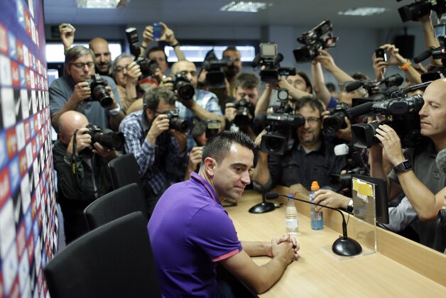 FC Barcelona's Xavi Hernandez attends a press conference at the Sports Center FC Barcelona Joan Gamper in San Joan Despi, Spain, Thursday, May 21, 2015. Barcelona midfielder Xavi Hernandez says he will leave the Catalan club after 17 trophy-laden seasons in which he set club records for appearances and titles won. The 35-year-old Xavi, who has played 764 matches for Barcelona, says he will cut his contract short by one year and leave after this season to go play for Qatari club Al-Sadd on a two-year contract. (AP Photo/Manu Fernandez)