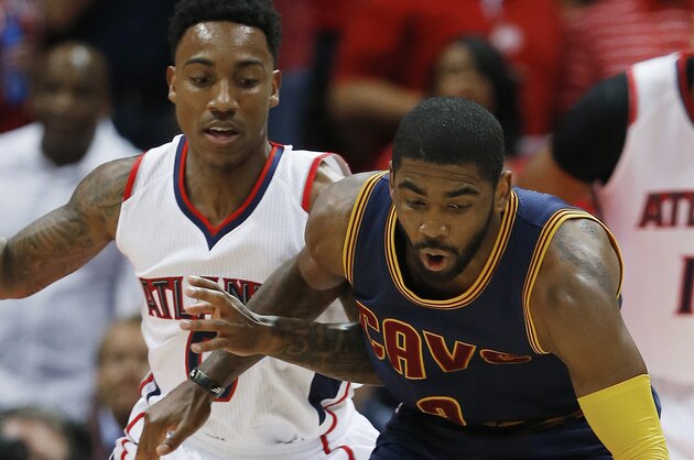 Cleveland Cavaliers guard Kyrie Irving (2) moves the ball as Atlanta Hawks guard Jeff Teague (0) looks on during the first half in Game 1 of the Eastern Conference finals of the NBA basketball playoffs, Wednesday, May 20, 2015, in Atlanta. (AP Photo/John Bazemore)