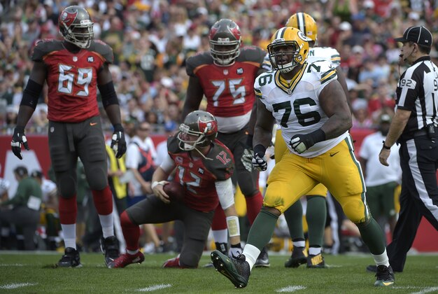 Green Bay Packers defensive end Mike Daniels (76) reacts after sacking Tampa Bay Buccaneers quarterback Josh McCown (12) during the first half of an NFL football game in Tampa, Fla., Sunday, Dec. 21, 2014. (AP Photo/Phelan M. Ebenhack)