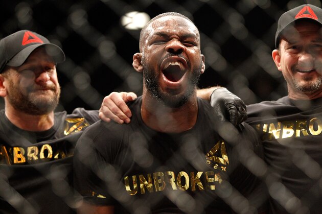 LAS VEGAS, NV - JANUARY 03:  Jon Jones (C) yells out after defeating Daniel Comier in a light heavyweight title fight at the MGM GrandGarden Arena on January 3, 2015 in Las Vegas, Nevada. Jones retained his title by unanimous decision.  (Photo by Steve Marcus/Getty Images)