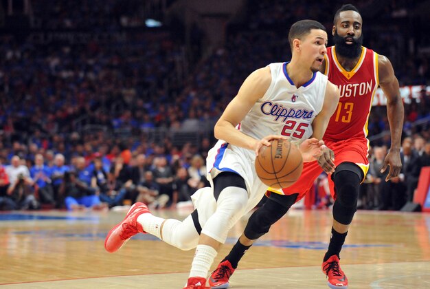 May 8, 2015; Los Angeles, CA, USA; Los Angeles Clippers  guard Austin Rivers (25) moves the ball ahead of Houston Rockets guard James Harden (13) during the second half in game three of the second round of the NBA Playoffs. at Staples Center. Mandatory Credit: Gary A. Vasquez-USA TODAY Sports