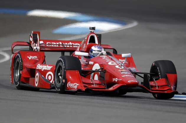 Scott Dixon, of New Zealand, drives through a turn during practice for the Grand Prix of Indianapolis auto race at the Indianapolis Motor Speedway in Indianapolis, Friday, May 8, 2015.  (AP Photo/Michael Conroy)