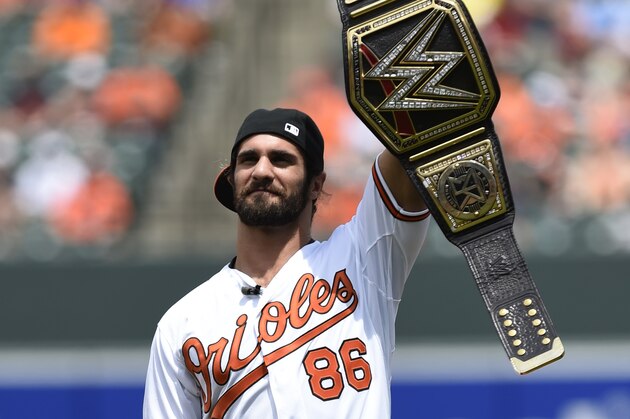 WWE world heavyweight champion Seth Rollins addresses the crowd before throwing out the ceremonial first pitch before the Baltimore Orioles and Los Angeles Angels baseball game, Sunday, May 17, 2015 in Baltimore. (AP Photo/Gail Burton)